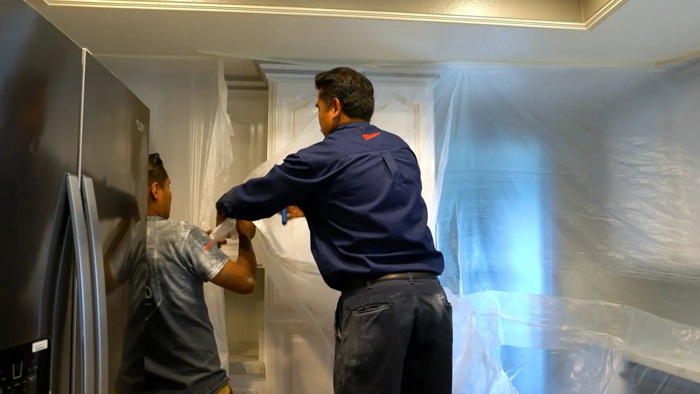 Plumbing team protecting a work area inside a home