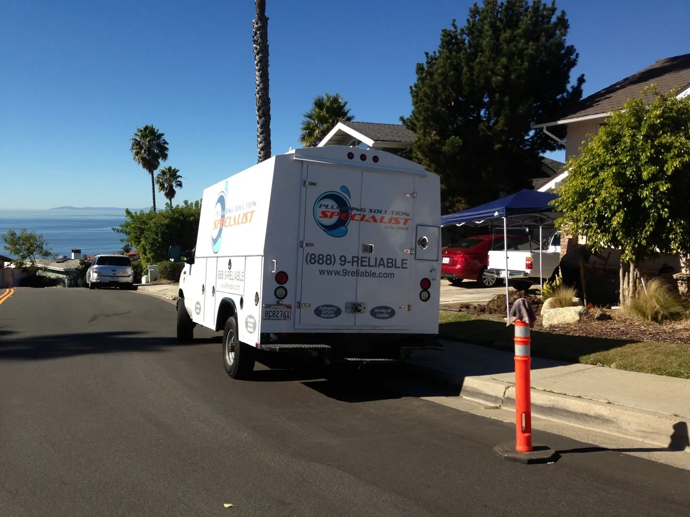 Plumbing Solution Specialist service truck parked on a street