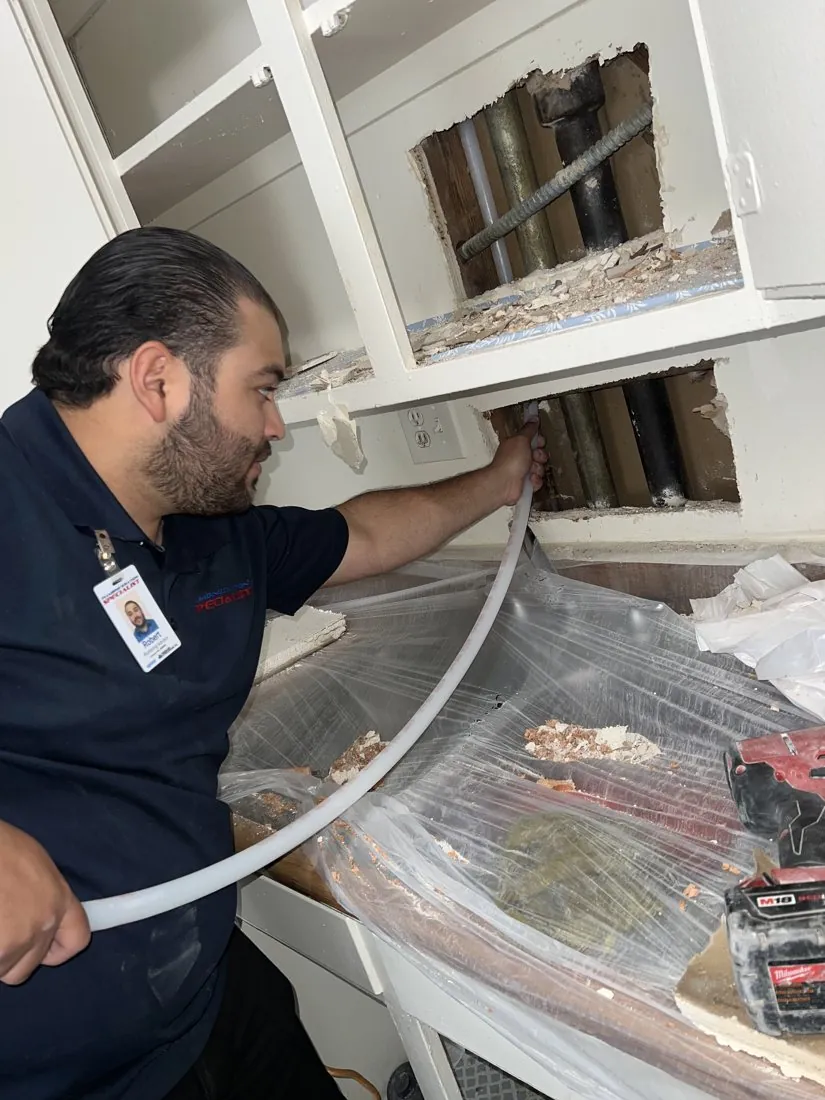 Technician working on exposed water lines